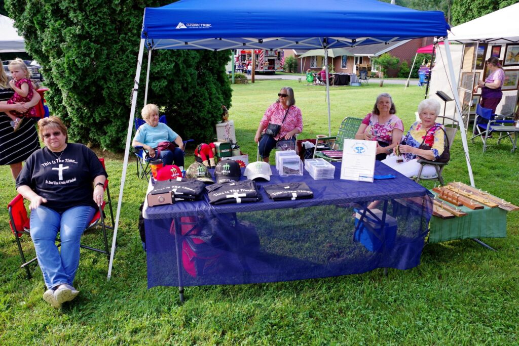 A picture of the vendor stand John and Melinda have set up at an event.